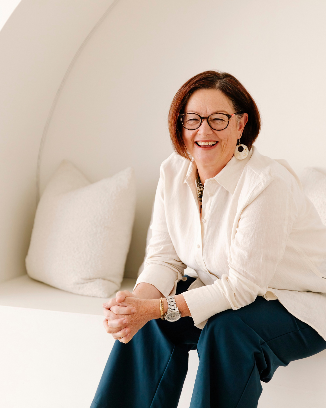 Naturopath Sharon Hespe smiling, wearing a white linen shirt