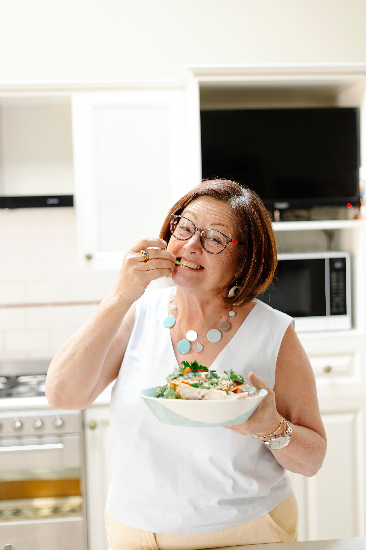 Sharon enjoying a gut-friendly salad in her kitchen